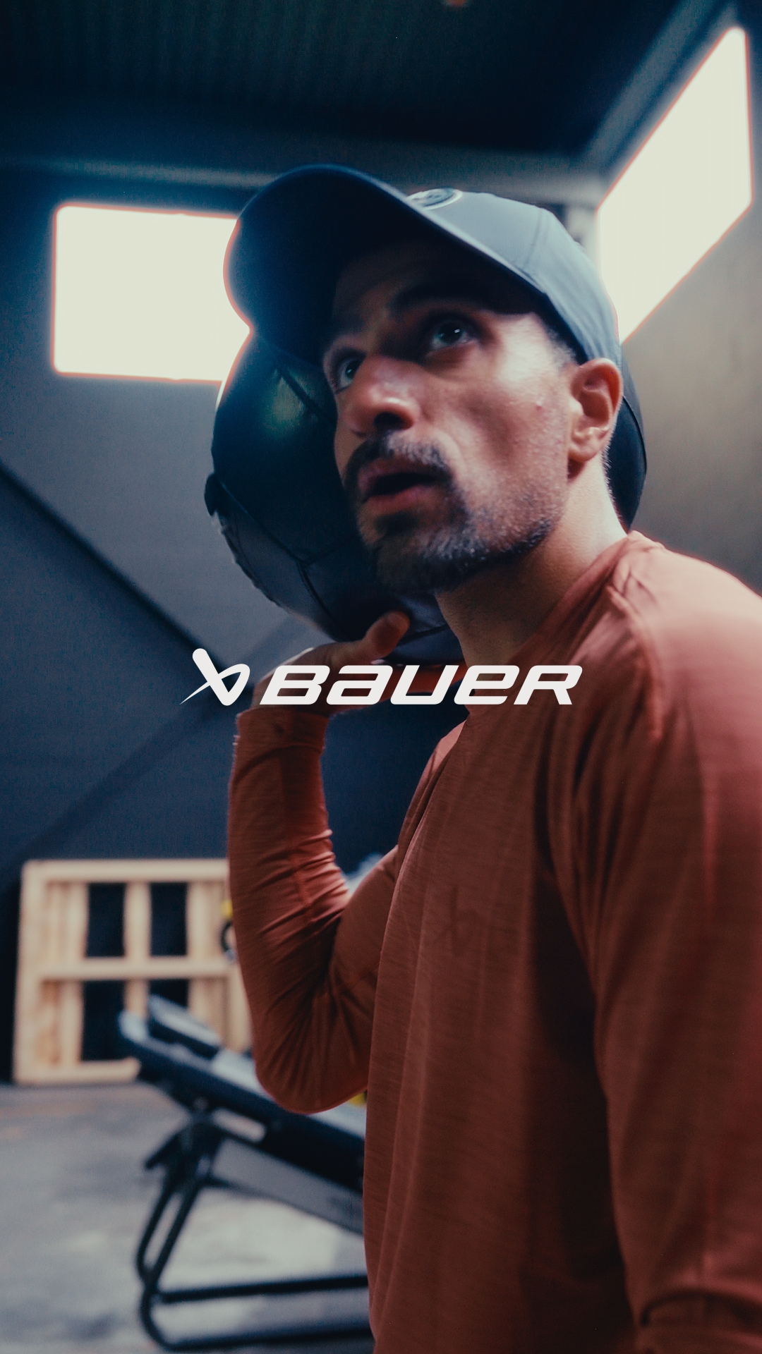 Hockey player rim-lit on outdoor ice at blue hour — Bauer brand film